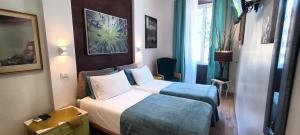 a hotel room with two beds and a window at Correa Vatican Hospitality in Rome