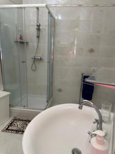 a bathroom with a white sink and a shower at Il Fauno in Contursi Terme +20 photos