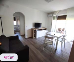 a living room with a couch and a table at Hotel Consul - Family Hotel in Riccione