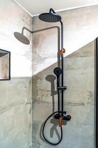 a shower in a bathroom with a shower head at Grgurić Apartments in Rab +156 photos