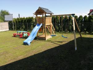 a playground with a slide and a gazebo at Domki Arcadia in Gąski