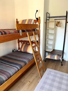 a room with two bunk beds and a shelf at Casa rústica com terraço e jardim in Águas +55 photos