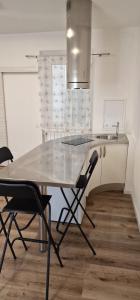 a kitchen with a table with two chairs and a sink at IL MARINAIO BED&RELAX in Livorno