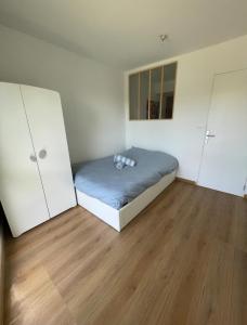a small bedroom with a bed and two closets at Appartement avec piscine in Saint-Laurent-du-Var +2 photos