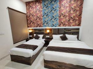 Voodi või voodid majutusasutuse Hotel GS Grand Amritsar toas