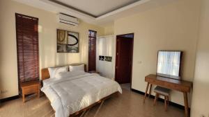 Postel nebo postele na pokoji v ubytování Ban Khun Tu Pool Villa + 28 fotografií