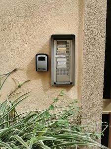 an old fashioned pay phone on the side of a building at Kikka's House in La Spezia