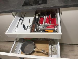 a drawer filled with cooking utensils in a kitchen at Kikka's House in La Spezia