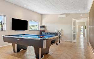 a room with a pool table and a flat screen tv at Cozy Home In Børkop With Sauna in Børkop