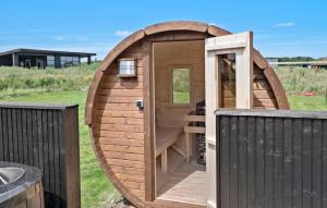 a large wooden dog house on a fence at Cozy Home In Børkop With Sauna in Børkop +18 photos