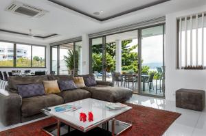 a living room with a couch and a table at Villa Oceane in Thong Son Beach