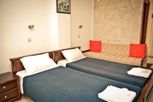a room with two beds and a couch at Erifili Kallithea in Kallithea Halkidikis