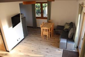a living room with a table and a couch at Checz pod Brzozami in Żuromino