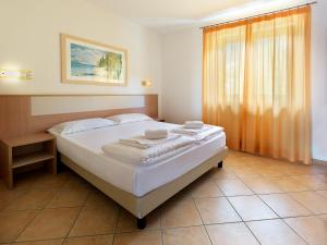 Postel nebo postele na pokoji v ubytování Residence Besass, GTSGroup