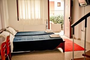 a bedroom with a bed and a red rug at Erifili Kallithea in Kallithea Halkidikis