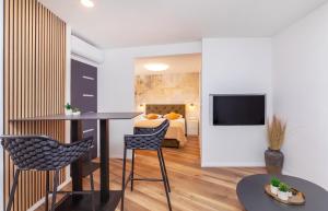 a room with a bed and a table and chairs at SoHo apartment on the waterfront in Mlini