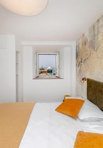 a bedroom with a large bed and a window at SoHo apartment on the waterfront in Mlini