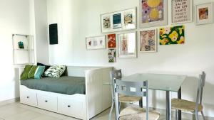 a small bedroom with a bed and a table at M375 - Marcelli, bilocale con giardino in residence con piscina in Numana