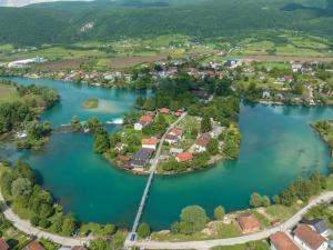 an aerial view of a town in the middle of a river at Amina River Apartment in Bihać