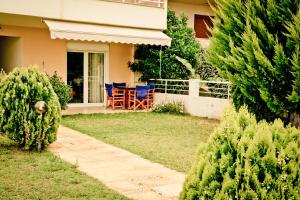 a house with a yard with a table and chairs at Erifili Kallithea in Kallithea Halkidikis