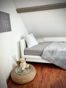 a bedroom with a bed and a teddy bear on a table at Pures Wohlfühlen mit privater Sauna & Garten in Meschede