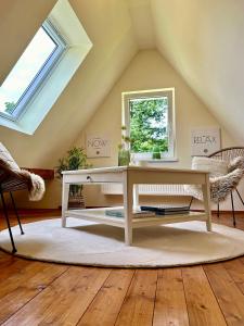a white desk in a attic with a window at Pures Wohlfühlen mit privater Sauna & Garten in Meschede