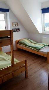 a bedroom with two bunk beds in a attic at Karwica 39G Mazury jezioro Nidzkie in Karwica