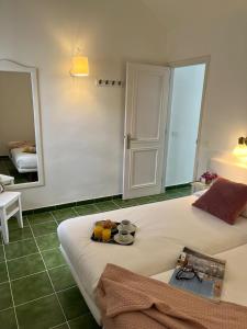 a bedroom with a bed with a tray of food on it at Bungalow Buganvilla in Tías +29 photos