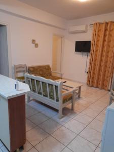 a living room with a bed and a table at Hellenic Sun in Lassi