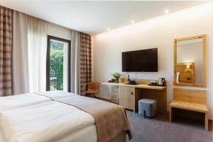 Televízia a/alebo spoločenská miestnosť v ubytovaní BIO HOTEL & WELLNESS Zlatý Hýľ