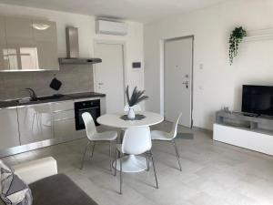 a kitchen with a table and chairs in a room at Massa Love Stay in Massa Marittima