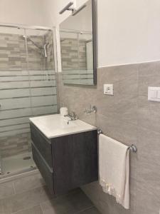 a bathroom with a sink and a shower at Massa Love Stay in Massa Marittima