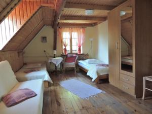 a bedroom with two beds and a staircase at Agroturystyka Pod Jesionami in Lądek-Zdrój +5 photos