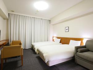 Dormy Inn Kanazawa Natural Hot Spring客房内的一张或多张床位