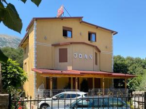 a building with a car parked in front of it at Joan Guesthouse in Përmet