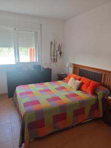 a bedroom with a bed with a colorful blanket at Apartamento A & M in Vera +20 photos