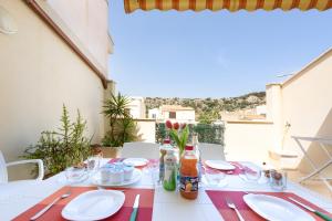 a table with plates and utensils on a balcony at A casa di nonna Vincenza in San Vito lo Capo