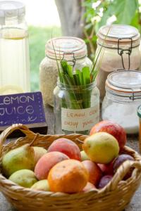 a basket of fruit and vegetables on a table at Natural Mystic Hostel in Costa da Caparica