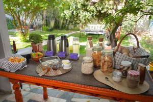 a table with a bunch of food and jars on it at Natural Mystic Hostel in Costa da Caparica