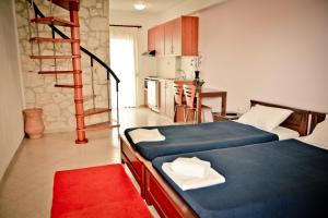 a room with two beds and a staircase in it at Erifili Kallithea in Kallithea Halkidikis