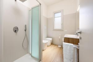 a bathroom with a shower and a toilet and a sink at A casa di nonna Vincenza in San Vito lo Capo