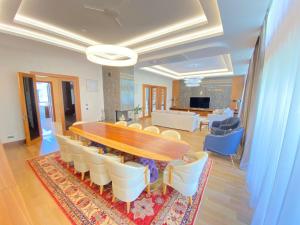 a conference room with a wooden table and chairs at Hotel Burabay in Shchūchīnsk