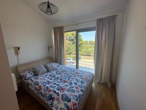 a bedroom with a bed and a large window at Beach House Mostir in Ugljan
