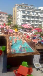 a group of people in a swimming pool at Sunrise Hotel Cameria in Durrës