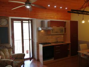 a kitchen with a stove and a ceiling fan at Casa Ruffo in Francavilla di Sicilia +14 photos