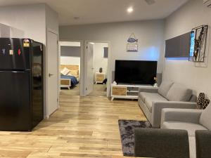 a living room with a couch and a television at Coastal Hideaway By Lake in Toukley