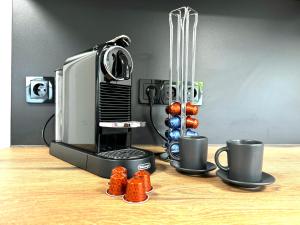 a coffee machine with two cups on a table at Big-Kurstadtapartment Baden-Baden in Baden-Baden