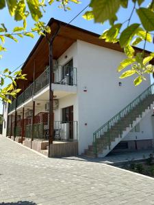 a building with a staircase on the side of it at Vila Bloom in Vama Veche