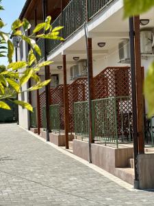 a building with a fence on the side of a street at Vila Bloom in Vama Veche