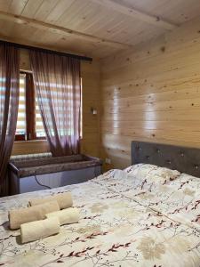 a bedroom with a bed in a wooden room at Apartman Sofiana in Bajina Bašta